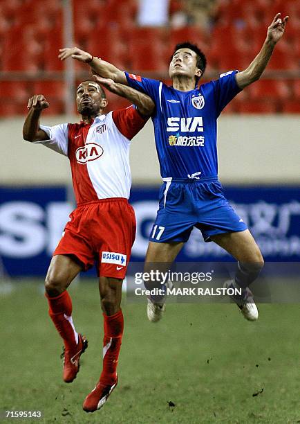 Costinha from the Spanish team Atletico Madrid clashes with Shanghai Shenhua player Sun Ji during their game at the Shanghai International Football...