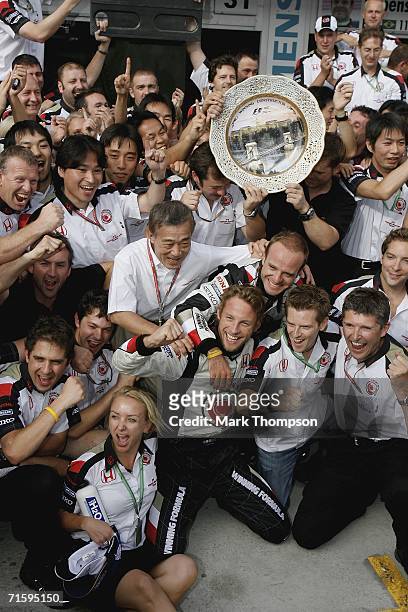 Jenson Button of Great Britain and Honda Racing celebrates victory with his team during the Hungarian Formula One Grand Prix at the Hungaroring on...
