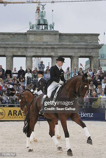 German riding champions Nadine Capelmann and Isabell Werth perform a pas de deux in front of the Brandenburg Gate at a promotional event for the...