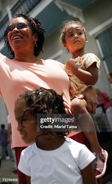 Onlookers watch as paraders march in the Satchmo Summerfest Second Line Parade August 6, 2006 in New Orleans, Louisiana. The festival honors jazz...