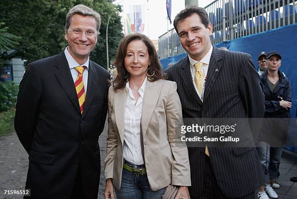 German politician Guido Westerwelle , singer Vicky Leandros and Westerwelle's partner Michael Mronz pose for a photograph after attending a...