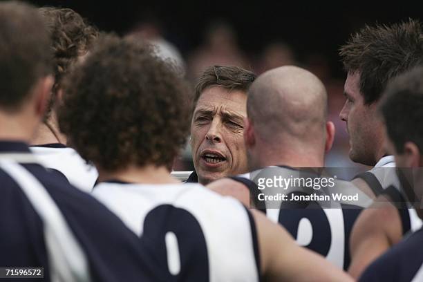 Mark Thompson of Geelong speaks to his players at three quarter time during the round 18 AFL match between the Brisbane Lions and Geelong at the...