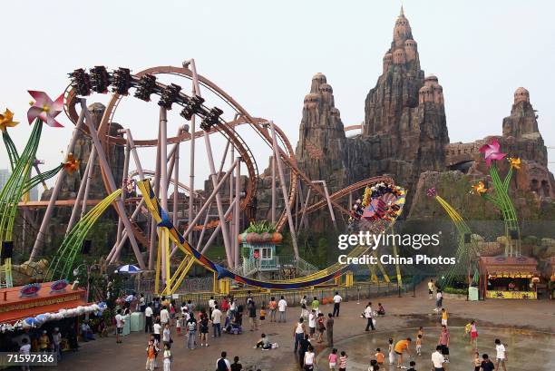 Tourists enjoy the rides at Chinese Theme Park "Happy Valley" on August 6, 2006 in Beijing, China. Happy Valley, the biggest theme park in China,...