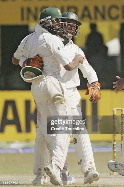 Hashim Amla and Mark Boucher of South Africa celebrate the wicket of Sanath Jayasuriya of Sri Lanka during the fourth day of the 2nd Test between Sri...