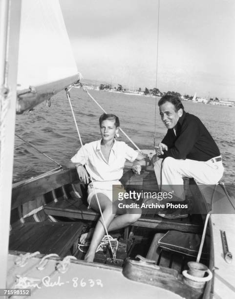 Actors Lauren Bacall and Humphrey Bogart enjoy a day's sailing, circa 1945.