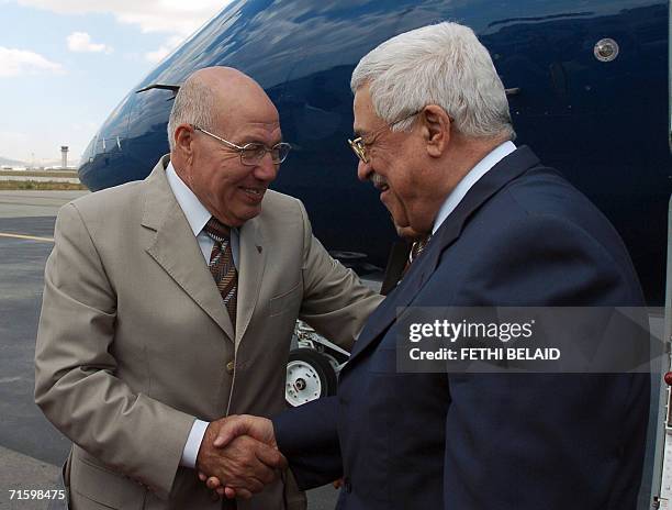 Tunisian government minister and advisor to the president Abdelaziz Ben Dhia greets Palestinian leader Mahmud Abbas upon his arrival at...