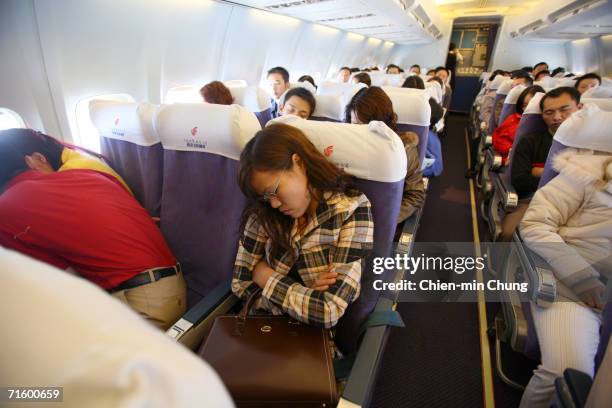 Susie Cheng sleeps during her flight to Sichuan on December 3, 2005 in Guangdong Province, China.