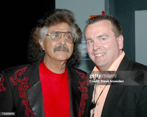 Mexican-American singer/guitarist Freddy Fender poses backstage with Route 66 Casino's Entertainment Manager Bob Buhl at Route 66 Casino's Legends...