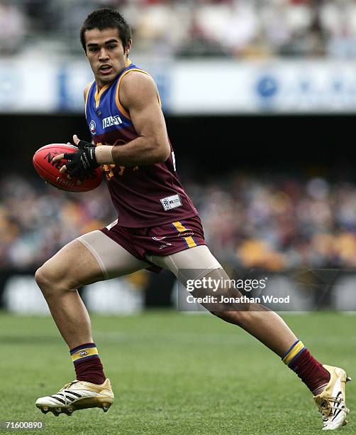 Scott Harding of the Lions runs the ball forward during the round 18 AFL match between the Brisbane Lions and the Geelong Cats at the Gabba on August...