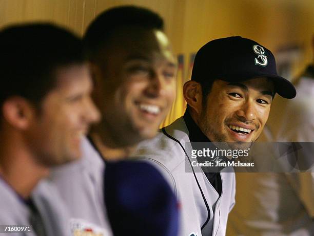 American League All-Star outfielder Ichiro Suzuki laughs in the dugout with teammates shortstop Derek Jeter and shortstop Michael Young during the...