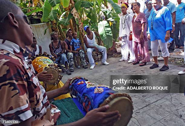 Members of a Cuban Yoruba community play "taba" drums and sing during an Afro-Cuban ritual asking for a fast recovery of Cuban President Fidel Castro...
