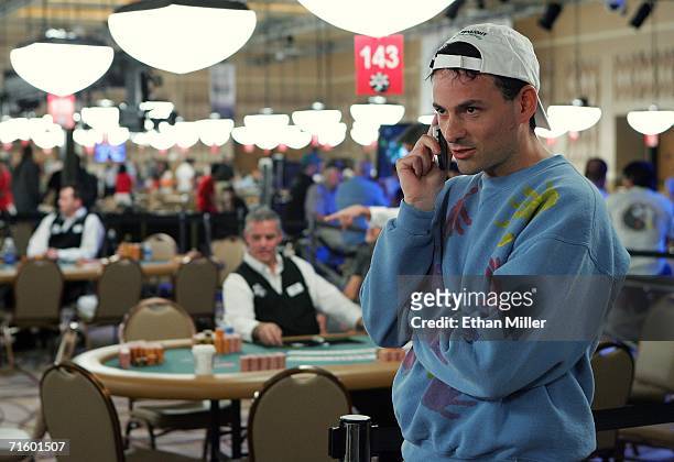 David Einhorn of New York talks on his cell phone during a break in the action at the World Series of Poker no-limit Texas Hold 'em main event at the...