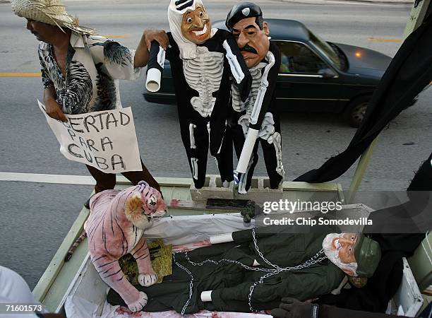 In a macabre display, a likeness of Cuban leader Fidel Castro in a casket is accompanied by Cuban immigrant Reynando Martinez of Miami and mannequins...