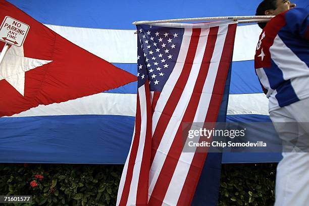 German Sabogal of Miami sells Cuban flags while standing along Calle Ocho in the Little Havana neighborhood Aug. 7, 2006 in Miami, Florida. The Cuban...