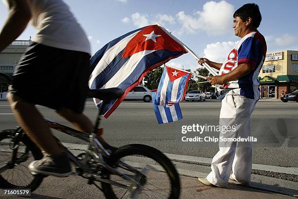 German Sabogal of Miami sells Cuban flags while standing along Calle Ocho in the Little Havana neighborhood August 7, 2006 in Miami, Florida. The...