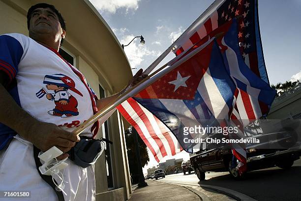 German Sabogal of Miami sells Cuban flags while standing along Calle Ocho in the Little Havana neighborhood August 7, 2006 in Miami, Florida. The...