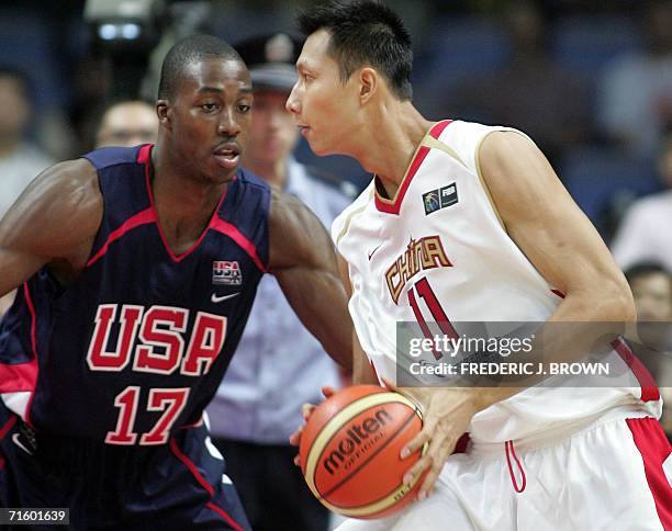 China's Yi Jianlian tries to get past Dwight Howard of the United States, 07 August 2006 at the China Basketball Challenge in Guangzhou, in southern...