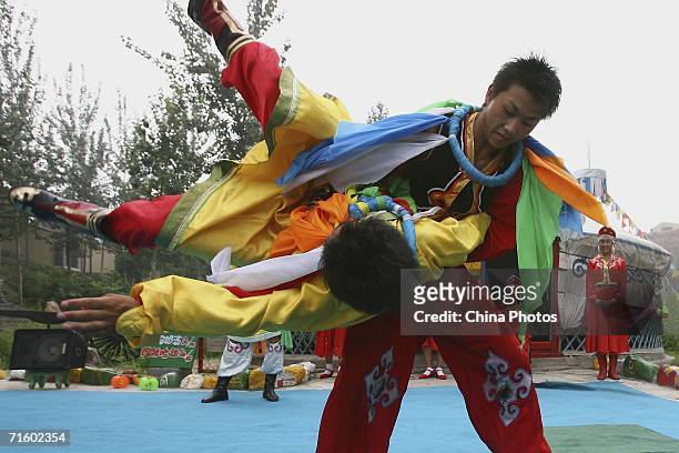 Mongolian entertainers perform traditional wrestling during a performance to mark the two-year countdown to the 2008 Beijing Olympic Games, at the...