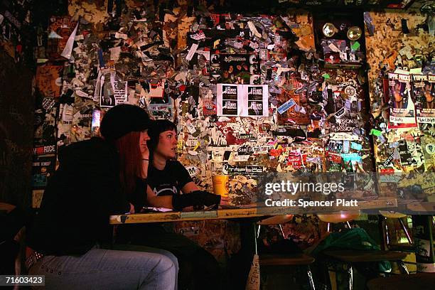 Two women watch a rock band at the club CBGB March 14, 2005 in New York City. It was announced on August 8, 2006 that CBGB's owner Hilly Kristal will...