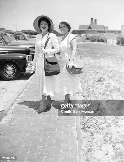 Hungarian actress Magda Gabor and her mother Jolie Gabor pause for a photograph on a brick path alongside the parking lot of the Southampton Bathing...