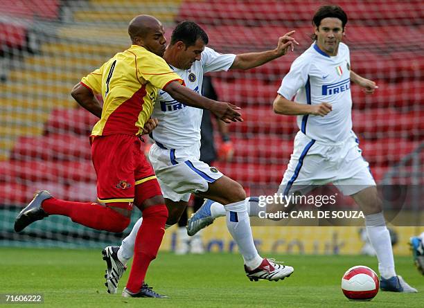 Watford, UNITED KINGDOM: Watford's Marlon King and Inter Milan's Dejan Stankovic battle for the ball during a friendly football match in Watford, 08...