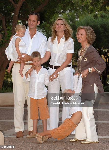 Princess Cristina of Spain with husband Inaki Urdangarin, Queen Sofia and sons Irene, Juan Valentin and Miguel attend a photocall during their summer...