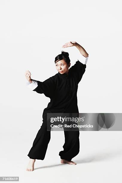 young woman practicing martial arts - tai chi shadow stock pictures, royalty-free photos & images
