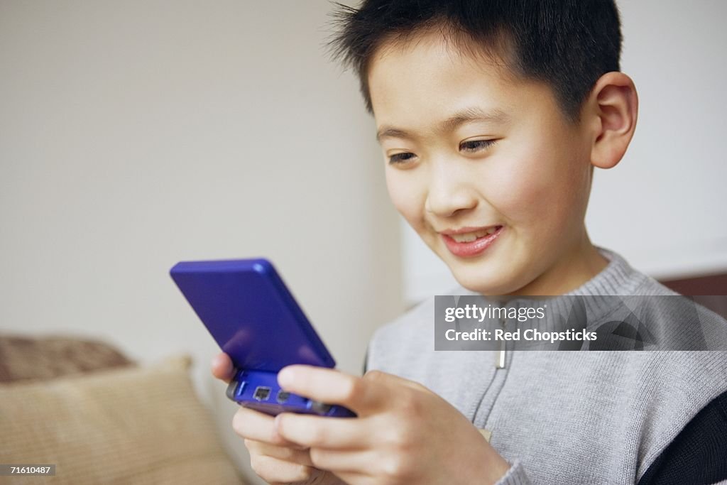 Close-up of a boy playing a video game