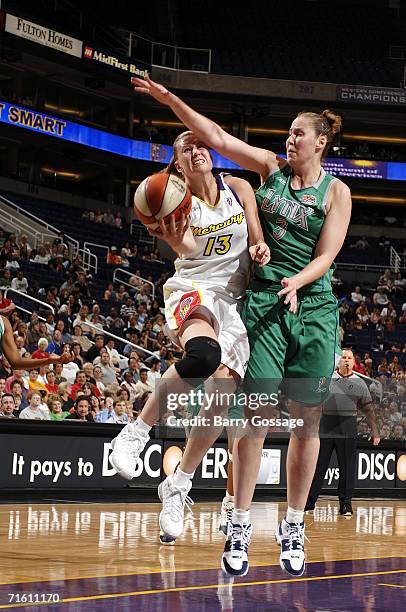 Penny Taylor of the Phoenix Mercury shoots against Nicole Ohlde of the Minnesota Lynx on August 8 at U.S. Airways Center in Phoenix, Arizona. NOTE TO...