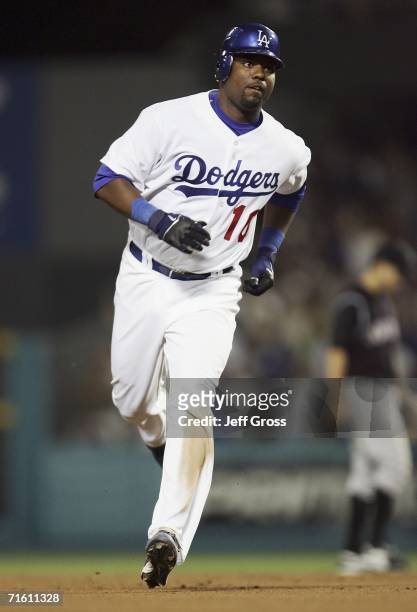 Wilson Betemit of the Los Angeles Dodgers rounds the bases after hitting a solo homerun to tie the game in the seventh inning during the game against...