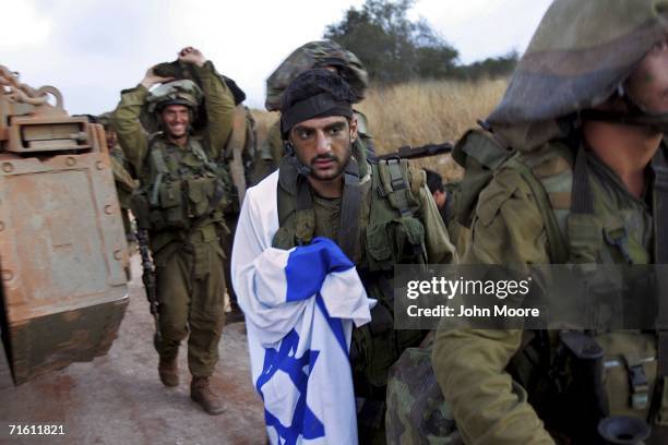 Israeli infantry soldiers cross the Lebanese border back into northern Israel August 9, 2006. The unit had been fighting Hezbollah militia for two...