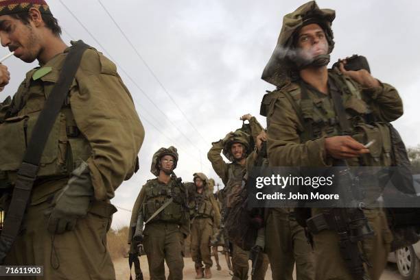 Israeli infantry soldiers cross the Lebanese border back into northern Israel August 9, 2006. The unit had been fighting Hezbollah militia for two...