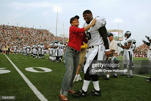 Sarah White , wife of hall of fame defensive end Reggie White, shares a moment with quarterback Donovan McNabb of the Philadelphia Eagless August 6,...