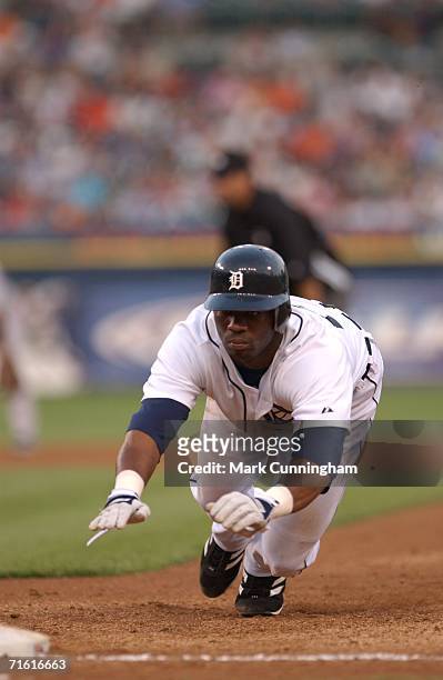 Craig Monroe of the Detroit Tigers dives head first back to first base during pick-off attempt during the game against the Boston Red Sox at Comerica...