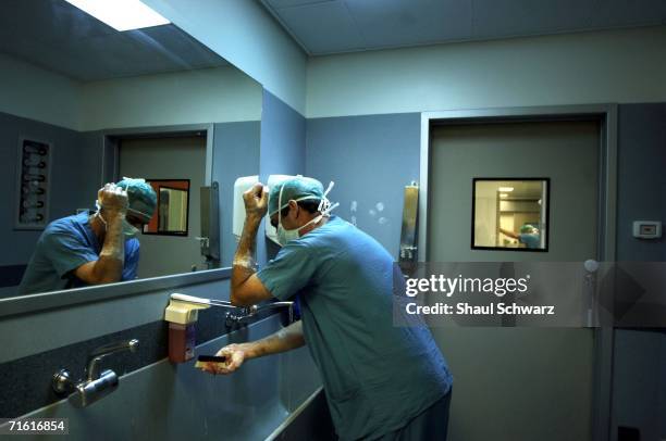 Doctor in the Nahariya hospital washes his hands before entering the operating room to work on a patient injured by a Hezbollah missile attack last...