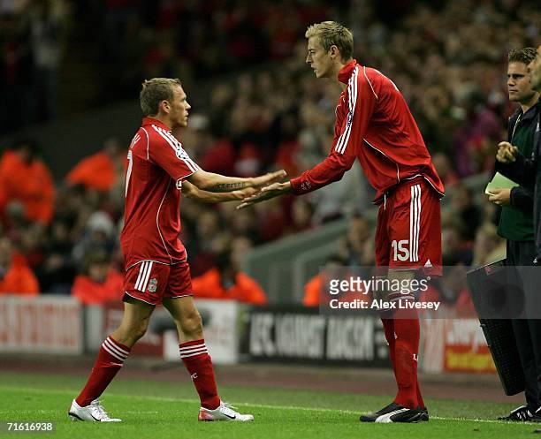 Craig Bellamy of Liverpool is substituted for team mate Peter Crouch during the UEFA Champions League third qualifying round 1st leg match between...