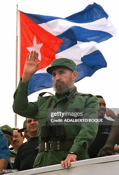 Cuban President Fidel Castro waves to participants of the traditional May Day parade attended by thousands of people in Havana's Plaza of the...