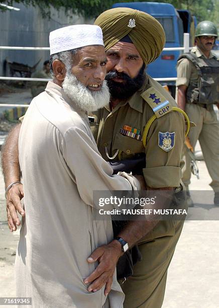 An Indian Central Reserve Police Force soldier searches a Kashmiri pedestrian outside the Bakshi Stadium, the venue for the fouthcoming country's...