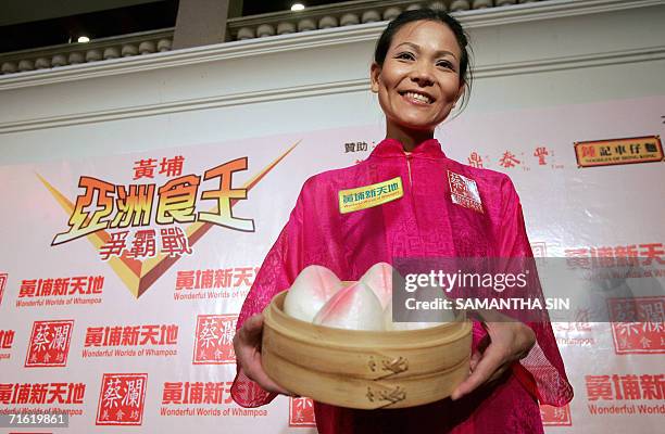 The womans world eating champion Sonya "Black Widow" Thomas from the US poses for a picture during a press conference for an Asia eating championship...