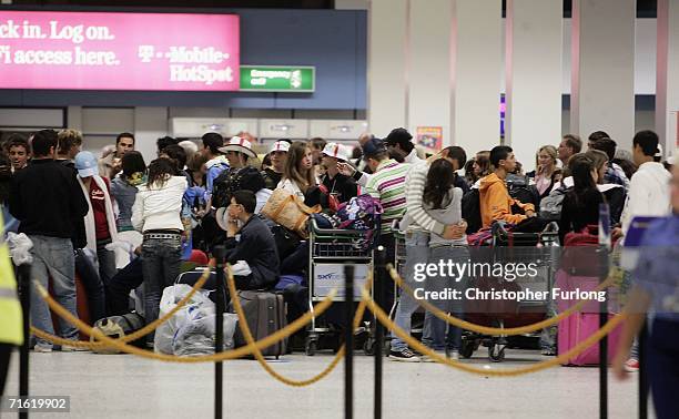 Passengers wait for their flights at Manchester Airport on August 10, 2006 in Manchester, England. British airports have been thrown into chaos as...