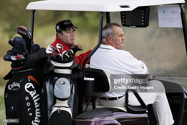 Nigel Mansell looks around as he drives the golf cart at Whittlebury Park Golf and Country Club prior to testing for the GP Masters of Great Britain...