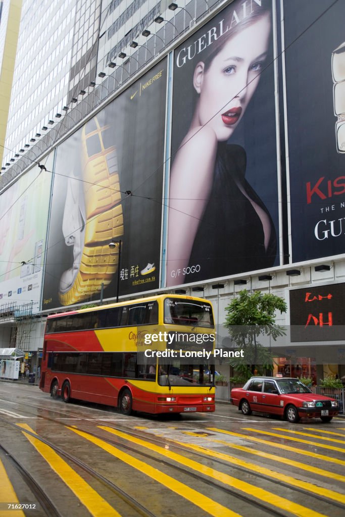Traffic passing billboards of Sogo department store, Causeway Bay, Hong Kong, China