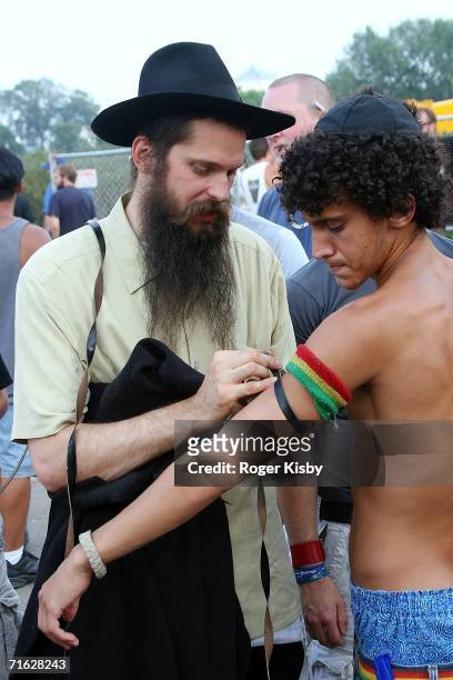Hasidic Jewish reggae singer Matisyahu wraps the Tefiloh on a fan after his performance at Lollapalooza on August 6, 2006 in Chicago, Illinois.