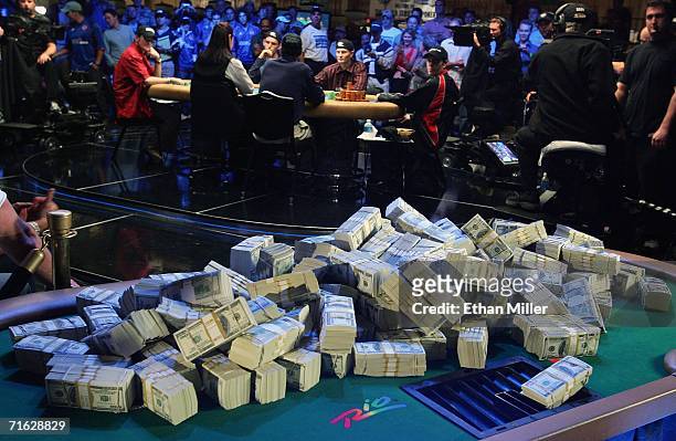 Players at the final table of the World Series of Poker no-limit Texas Hold 'em main event look back at a display of USD 12 million on display at the...