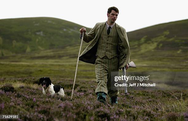 Gamekeeper Andrew Drummond walks with his springer spaniel on Drumochter Moore on the Milton Estate August on August 11, 2006 Dalwhinnie in...