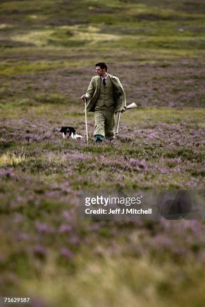 Gamekeeper Andrew Drummond walks with his springer spaniel on Drumochter Moore on the Milton Estate August on August 11, 2006 Dalwhinnie in...