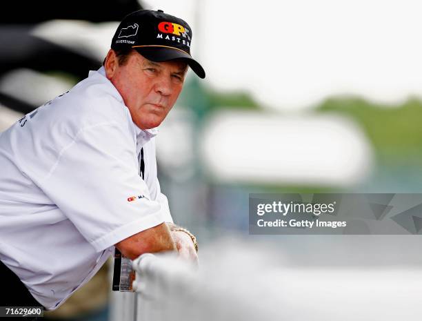 Alan Jones waits outside the pits during testing for the GP Masters of Great Britain at Silverstone circuit on August 11 in Silverstone, England.