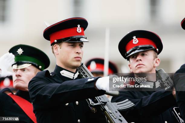 Prince William and fellow cadets hold an army issue SA80 riffle whilst taking part in a Passing Out Parade at Sandhurst Military Academy on August...