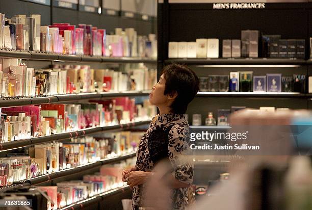 An woman browses through perfume at a Sephora cosmetics store in the international terminal at San Francisco International Airport August 11, 2006 in...