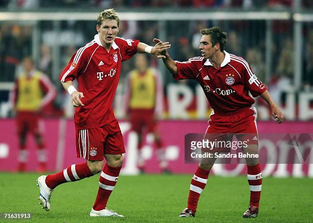 Bastian Schweinsteiger of Munich celebrates the second goal with his team mate Philipp Lahm during the Bundesliga match between FC Bayern Munich and...